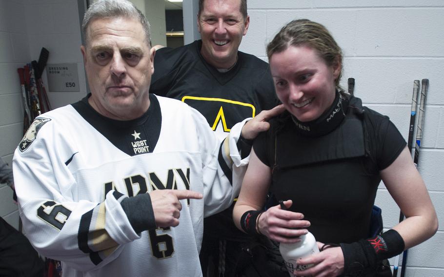Army team coach Gen. Mark Milley praises his goalie, Air Force Capt. Lindsey Colburn, after a hockey game against a Navy team at Verizon Center in Washington, D.C., Dec. 5, 2016. Colburn is commander of the Military Personnel Flight at Joint Base Anacostia Bolling. In the background is Under Secretary of the Army Patrick Murphy.