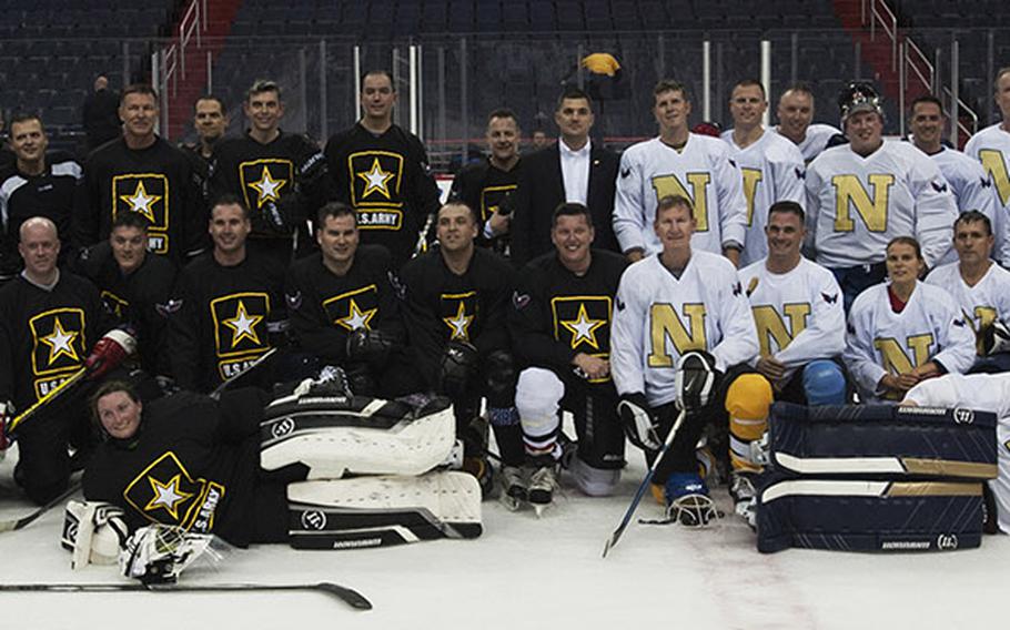Army and Navy players pose for a group photo after a hockey game at Verizon Center in Washington, D.C., Dec. 5, 2016.