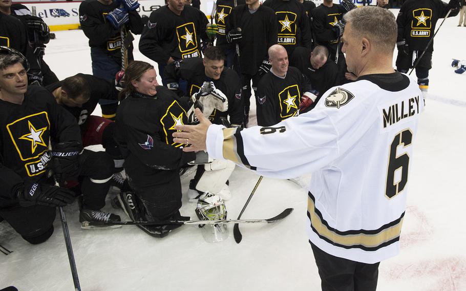 Army coach Gen. Mark Milley lines up his players for a team photo after a hockey game at Verizon Center in Washington, D.C., Dec. 5, 2016.