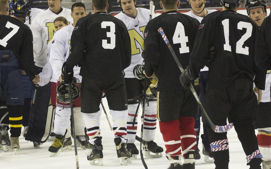 Army and Navy players, including Under Secretary of the Army Patrick Murphy (3), shake hands after a hockey game at Verizon Center in Washington, D.C., Dec. 5, 2016.