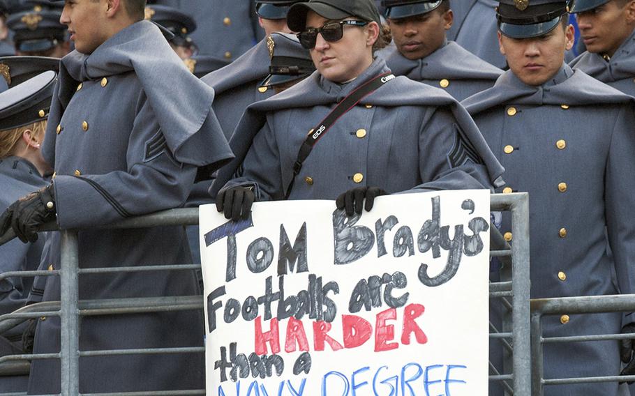 On West Point's side, a cadet holds a taunting sign befor the start of the Army-Navy game on Dec. 10, 2016, in Baltimore.
