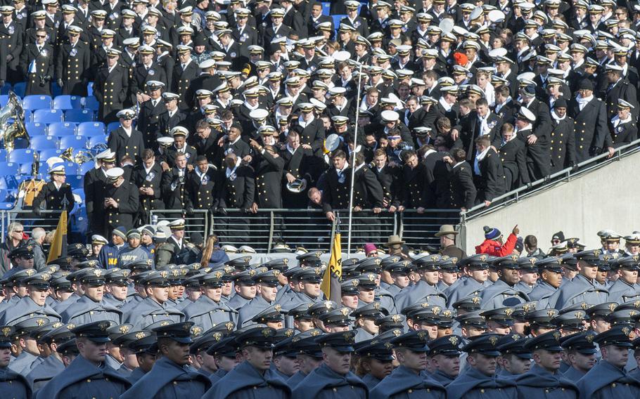 Navy midshipmen watch as West Point cadets march onto the field before the Army-Navy game on Dec. 10, 2016, in Baltimore.