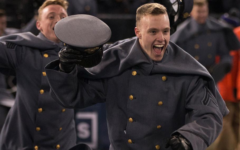 Army cadets rush onto the field after their team beat Navy, 21-17, at Baltimore, Md., Dec. 10, 2016.