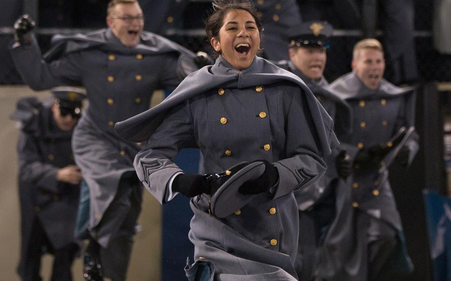 Army cadets rush onto the field after their team beat Navy, 21-17, at Baltimore, Md., Dec. 10, 2016.