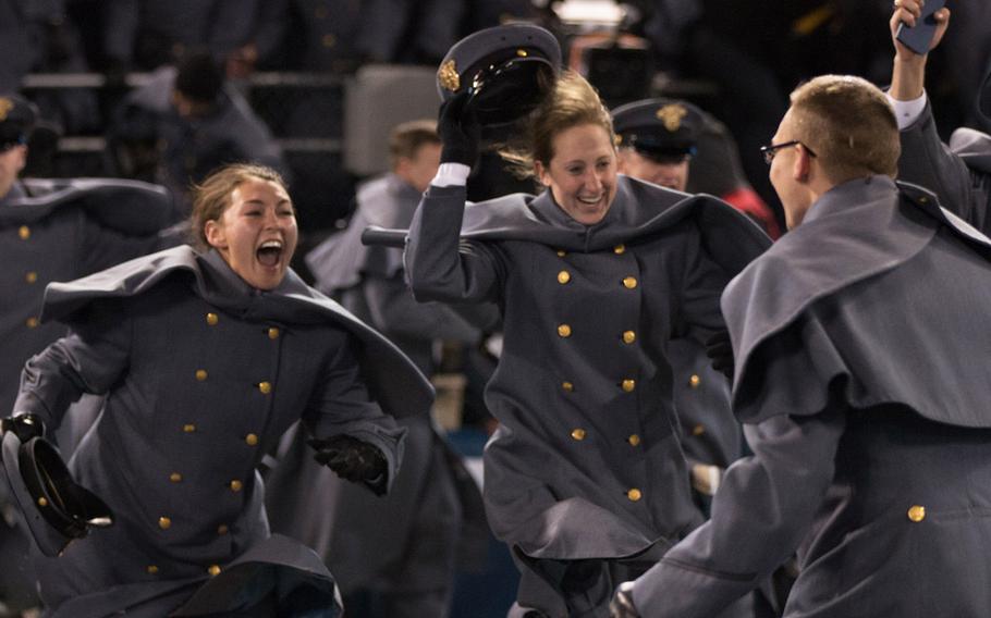 Army cadets rush onto the field after their team beat Navy, 21-17, at Baltimore, Md., Dec. 10, 2016.