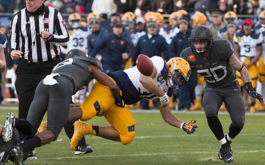 Navy fullback Shawn White coughs up the ball in the first half of the annual Army-Navy game held on Dec. 10, 2016. Army defeated the Midshipmen, 21-17. 