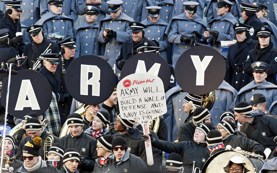 In a nod to fellow spectator President-elect Donald Trump, Army fans send a message to Navy during the Army-Navy game at M&T Bank Stadium in Baltimore, Md., Dec. 10, 2016. Army won, 21-17.