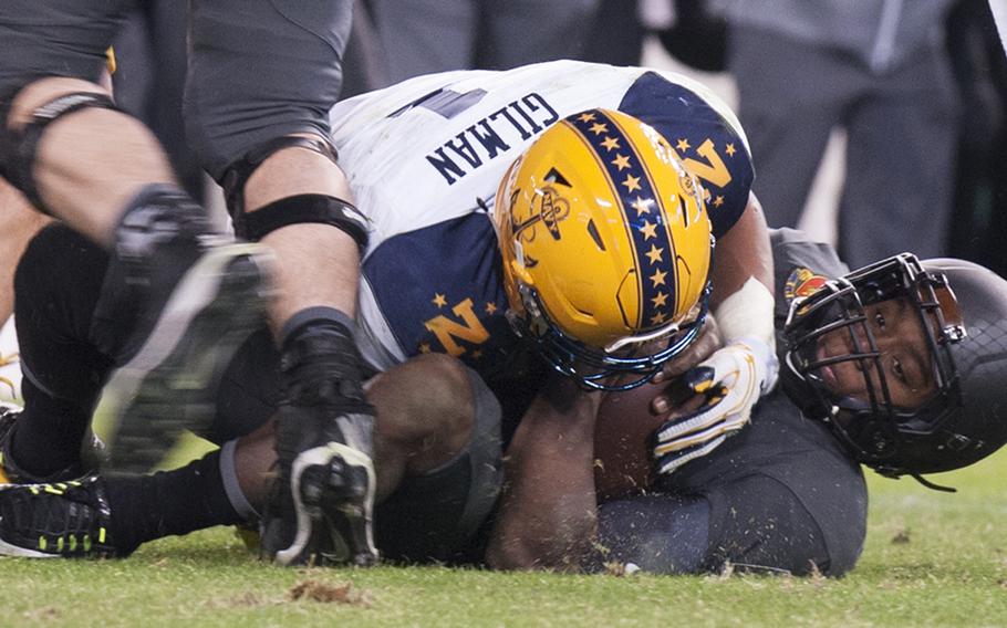 Navy's Alohi Gilman fights for the ball during the Army-Navy game at M&T Bank Stadium in Baltimore, Md., Dec. 10, 2016. Army won, 21-17.