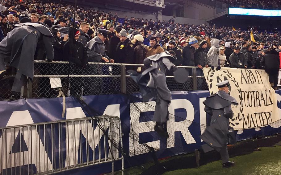 
Army fans pour onto the field at the end of the Army-Navy game at M&T Bank Stadium in Baltimore, Md., Dec. 10, 2016. Army won, 21-17.