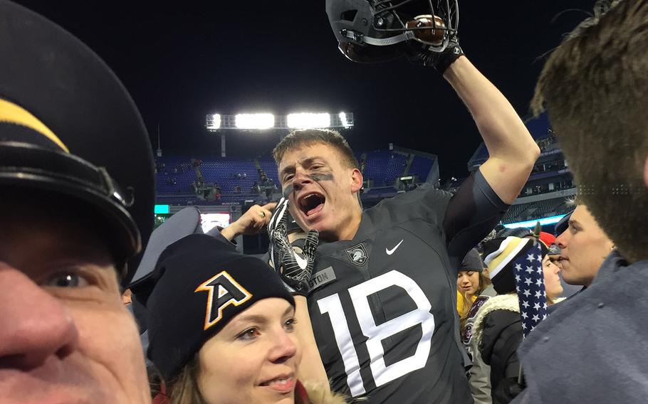 Kicker Blake Wilson leads Army players and fans in celebration at the end of the Army-Navy game at M&T Bank Stadium in Baltimore, Md., Dec. 10, 2016. Army won, 21-17. 