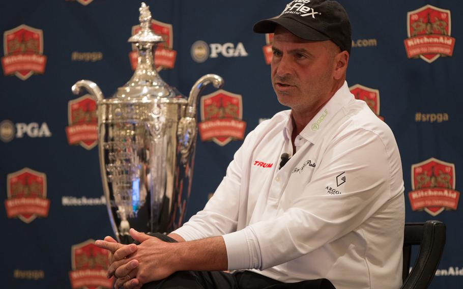 Rocco Mediate, defending champion of the Senior PGA Championship tournament, sits next to his trophy during a press conference for this year's Senior PGA tournament, to be held at the Trump National Golf Club in Potomac Falls, Virginia. Mediate, along with PGA of America president Paul Levy and Eric Trump were spoke to members of the press from the Trump International Hotel in Washington on Thursday, March 9, 2017.