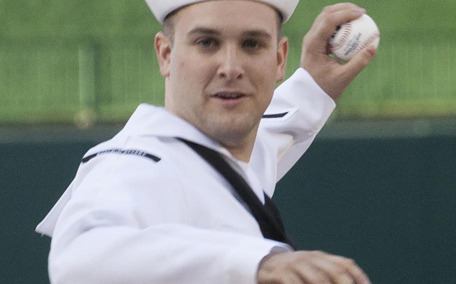 Intelligence Specialist 2nd Class Sean Grimes, Secretary of the Navy sailor of the year, winds up to deliver the ceremonial first pitch on U.S. Navy Day at Nationals Park in Washington, D.C., May 3, 2017.