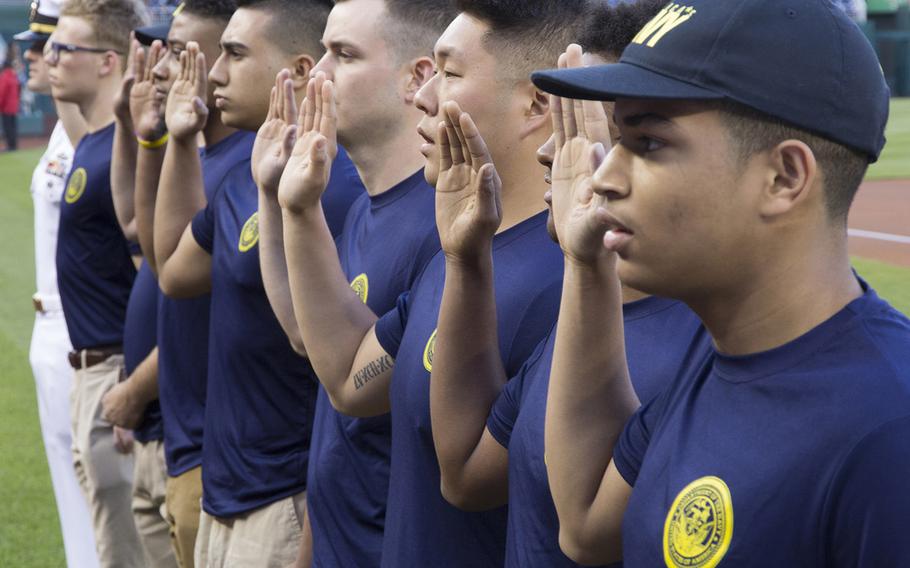 New sailors take the Oath of Enlistment on U.S. Navy Day at Nationals Park in Washington, D.C., May 3, 2017.