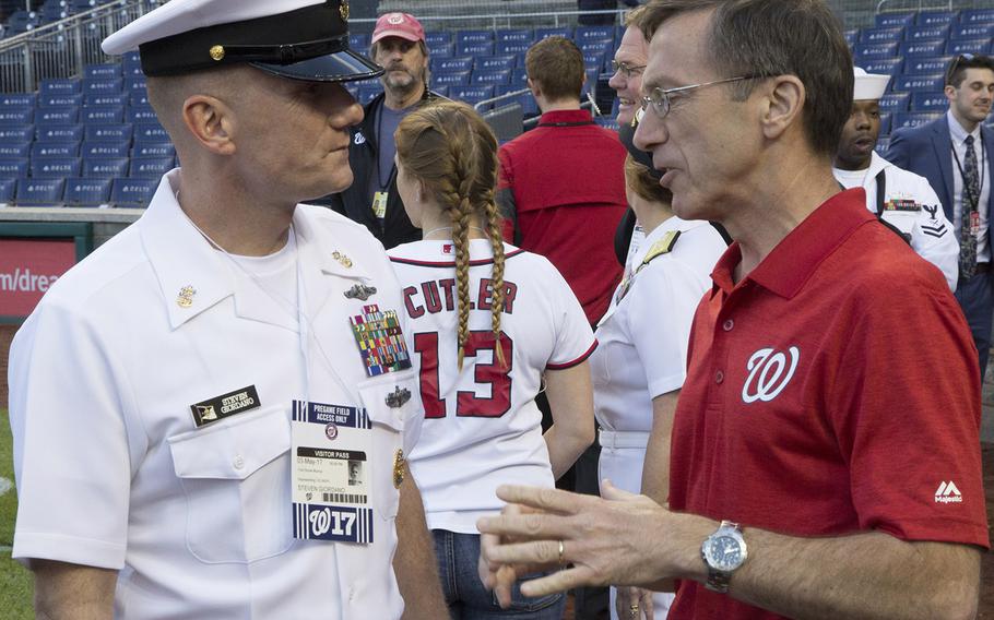 Master Chief Petty Officer of the Navy Steven Giordano talks with Acting Secretary of the Navy Sean Stackley on U.S. Navy Day at Nationals Park in Washington, D.C., May 3, 2017.