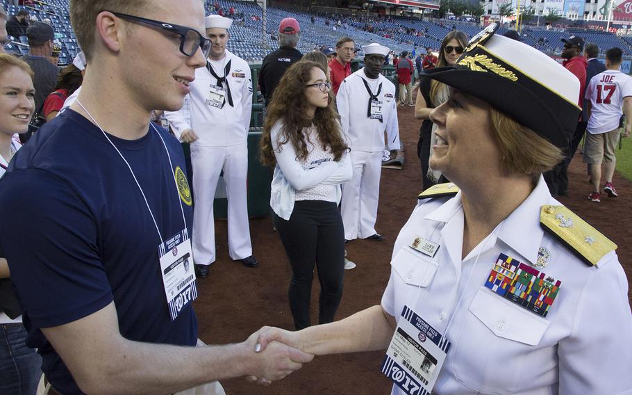Rear Adm. Dawn E. Cutler, U.S. Navy Chief of Information, talks with soon-to-be sailor Jerico Johanson on U.S. Navy Day at Nationals Park in Washington, D.C., May 3, 2017.