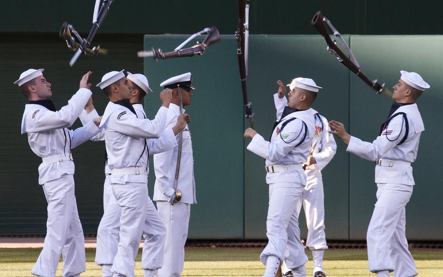 The U.S. Navy Ceremonial Guard drill team performs on U.S. Navy Day at Nationals Park in Washington, D.C., May 3, 2017.