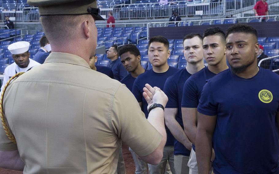 Soon-to-be sailors are briefed on the procedures for their swearing-in ceremony on U.S. Navy Day at Nationals Park in Washington, D.C., May 3, 2017.