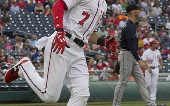 Trae Turner of the Washington Nationals and Atlanta Braves pitcher Mike Foltynewicz watch the flight of the ball on Turner's first-inning home run at Nationals Park in Washington, D.C., June 12, 2017. The Braves won, 11-10.