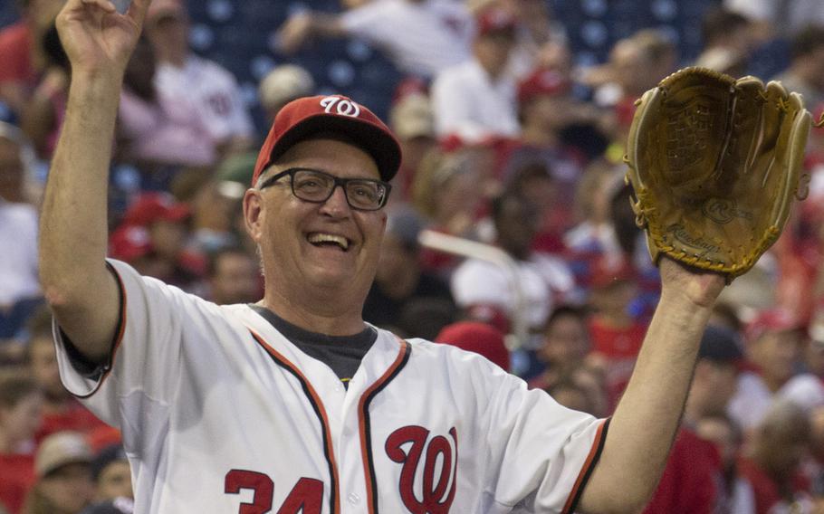A fan shows off his foul-ball souvenir on U.S. Army Day at Nationals Park in Washington, D.C., June 12, 2017.