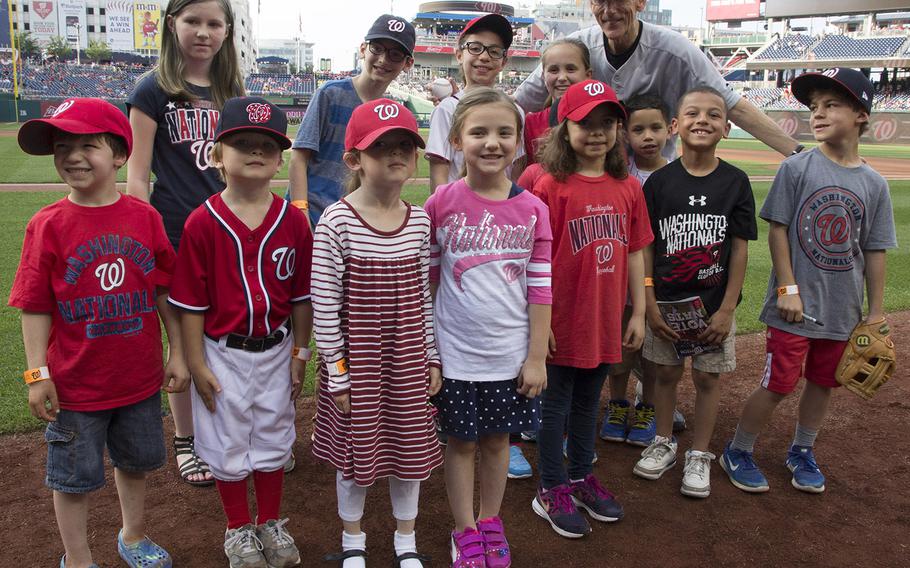 Acting Secretary of the Army Robert M. Speer poses for a photo with soldiers' children on U.S. Army Day at Nationals Park in Washington, D.C., June 12, 2017.