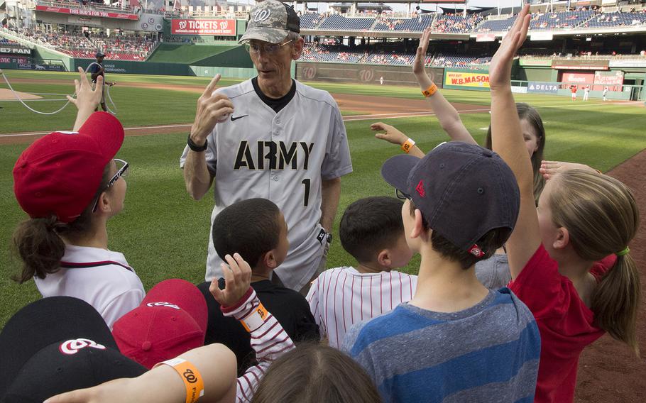 Acting Secretary of the Army Robert M. Speer talks with soldiers' children on U.S. Army Day at Nationals Park in Washington, D.C., June 12, 2017.