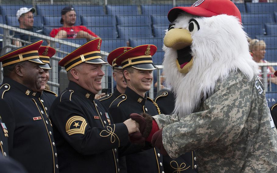 Washington Nationals mascot Screech talks with members of the Army Chorus of The United States Army Band on U.S. Army Day at Nationals Park in Washington, D.C., June 12, 2017.