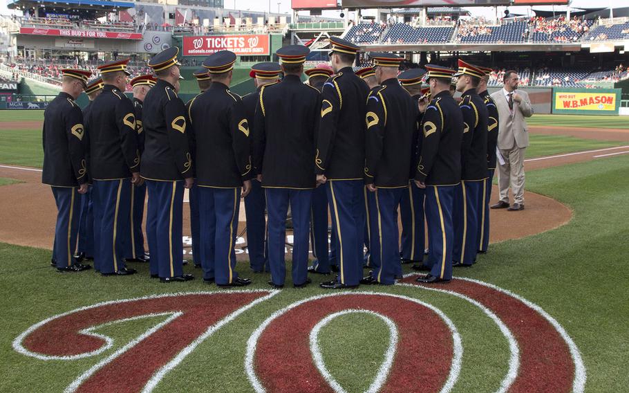 The Army Chorus of The United States Army Band prepares to perform the National Anthem on U.S. Army Day at Nationals Park in Washington, D.C., June 12, 2017.