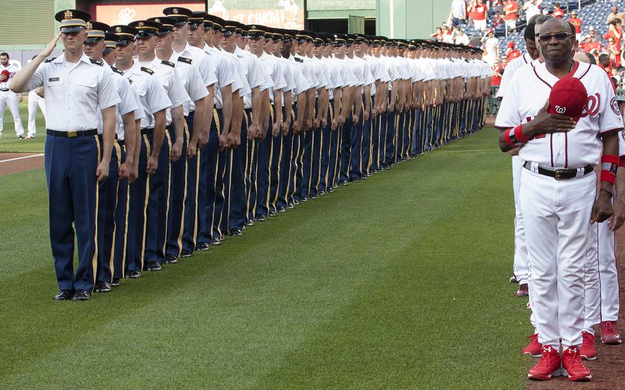 Manager Dusty Baker and the Washington Nationals are joined on the field by soldiers from the 1st and the 4th Battalions of the 3rd Infantry Regiment for the singing of the national anthem on U.S. Army Day at Nationals Park in Washington, D.C., June 12, 2017.