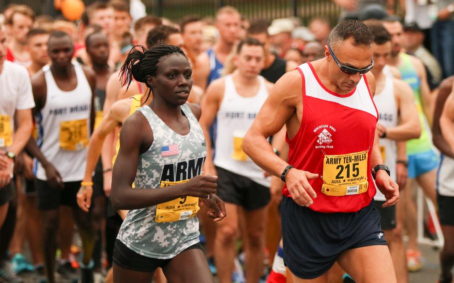 Runners stretch their legs ahead of the official start of the 33rd annual Army Ten-Miler in Washington, D.C., on Oct. 8, 2017. 