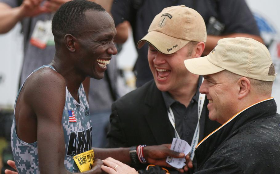 Spc. Haron Lagat is congratulated by Army Chief of Staff Gen. Mark Milley, right, at the end of the Army-Ten Miler held in Washington D.C., on Oct. 8, 2017.
