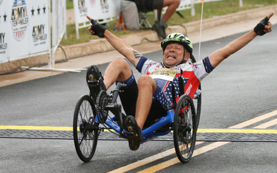 A participant celebrates crossing the finish line at the Army Ten-Miler in Washington, D.C., on Oct. 8, 2017.