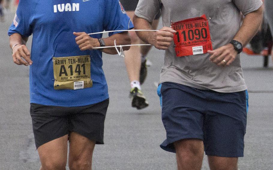 Retired Army officer Ivan Castro, left, who was blinded while serving in Iraq in 2006, competes in another Army Ten-Miler in Washington, D.C., Sunday, Oct. 8, 2017.
