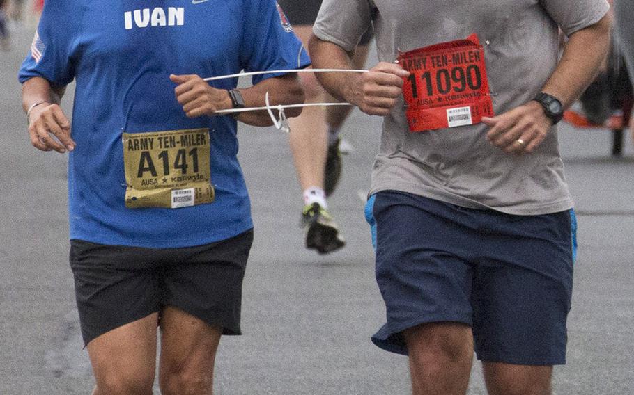 Retired Army officer Ivan Castro, left, who was blinded while serving in Iraq in 2006, competes in another Army Ten-Miler in Washington, D.C., Sunday, Oct. 8, 2017.
