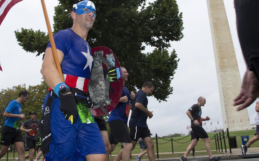 A runner in a Captain America outfit passes the Washington Monument during the Army Ten-Miler in Washington, D.C., Sunday, Oct. 8, 2017.
