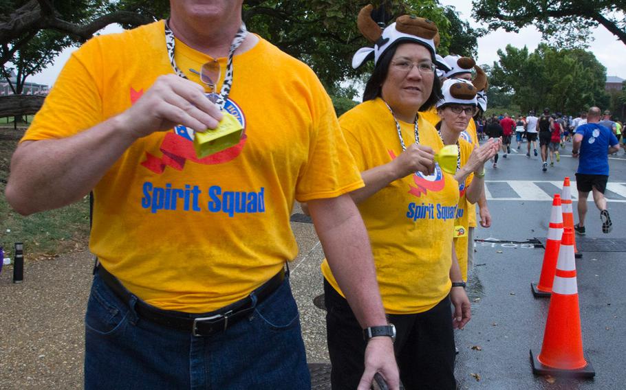 Spectators cheer the runners on during the Army Ten-Miler in Washington, D.C., Sunday, Oct. 8, 2017.
