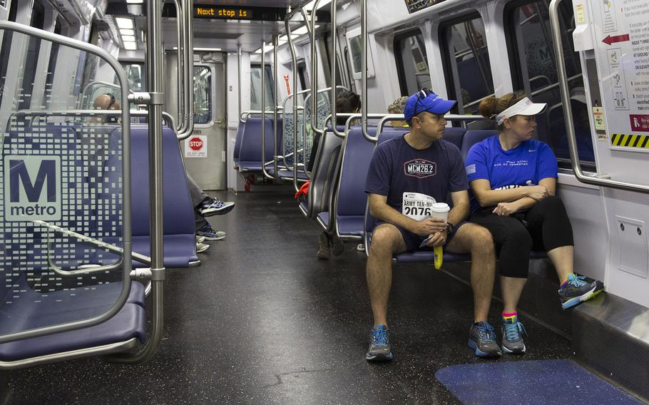 Two runners take the Metro to the Army Ten-Miler in Washington, D.C., Sunday, Oct. 8, 2017.
