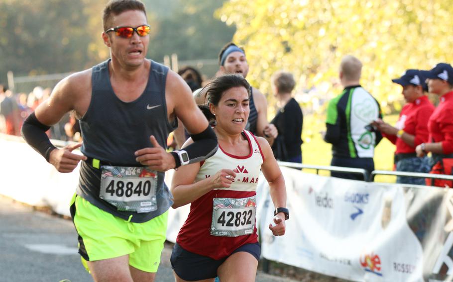 Runners partaking in the 10k run event as part of the overall 42nd Marine Corps Marathon festivities cross the finish line on Oct. 22, 2017.