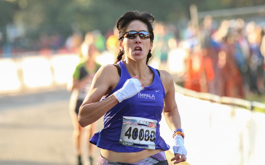 Silver Lumsdaine of Arlington, Va. crosses the finish line of the 10k run event, held in conjunction with the 42nd Marine Corps Marathon on Oct. 22, 2017.