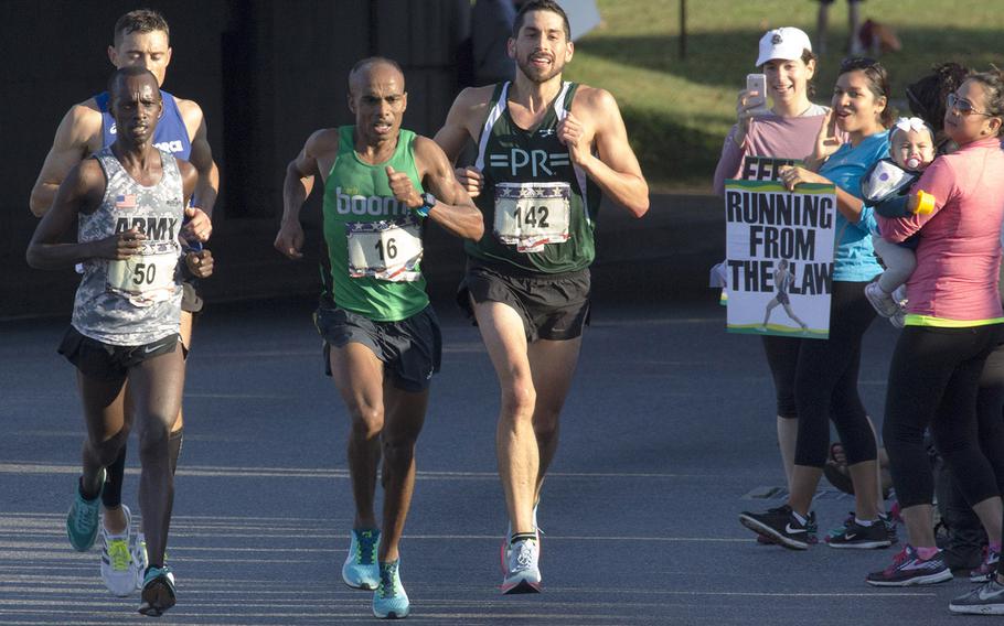 Desta Beriso Morkama (16)  of Arlington, Va., nears the 11-mile mark on his way to a win in the men's division of Sunday's Marine Corps Marathon in Washington, D.C., Oct. 22, 2017. With him are Jeffrey Stein (142) who finished eighth; Michael Biwott (50, sixth) and Kristopher Houghton 71, fourth).