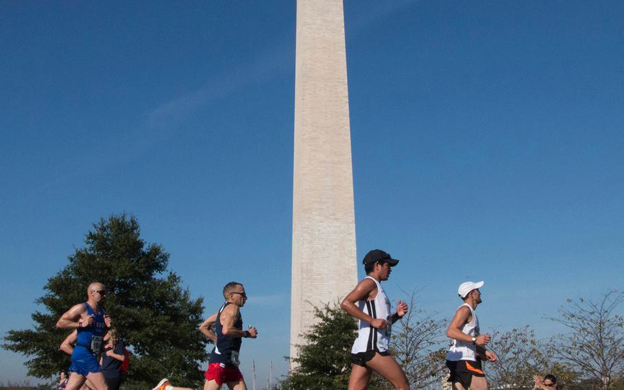 Runners in the Marine Corps Marathon pass the Washington Monument, Oct. 22, 2017.