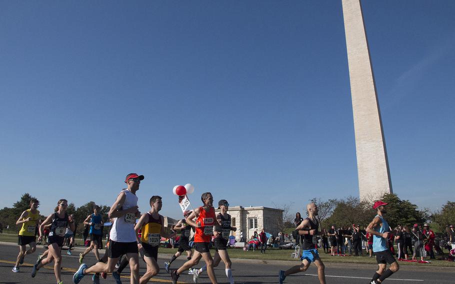 Runners in the Marine Corps Marathon pass the Washington Monument, Oct. 22, 2017.