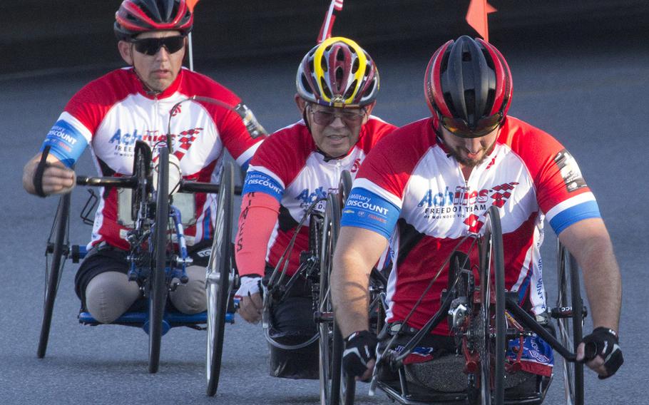 Competitors in the handcrank division of the Marine Corps Marathon approach the 11-mile mark in Washington, D.C., Oct. 22, 2017.