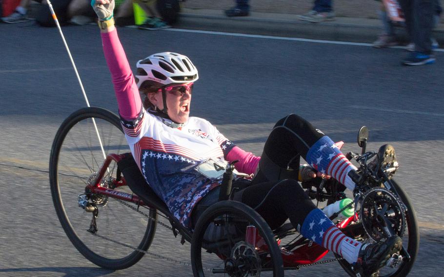 Gina Utegg of Tewksbury, Mass., fires up the crowd near the 10-mile mark in the Marine Corps Marathon, Oct. 22, 2017 in Washington, D.C. Utegg won the pushrim division in a time of 2:04:02.