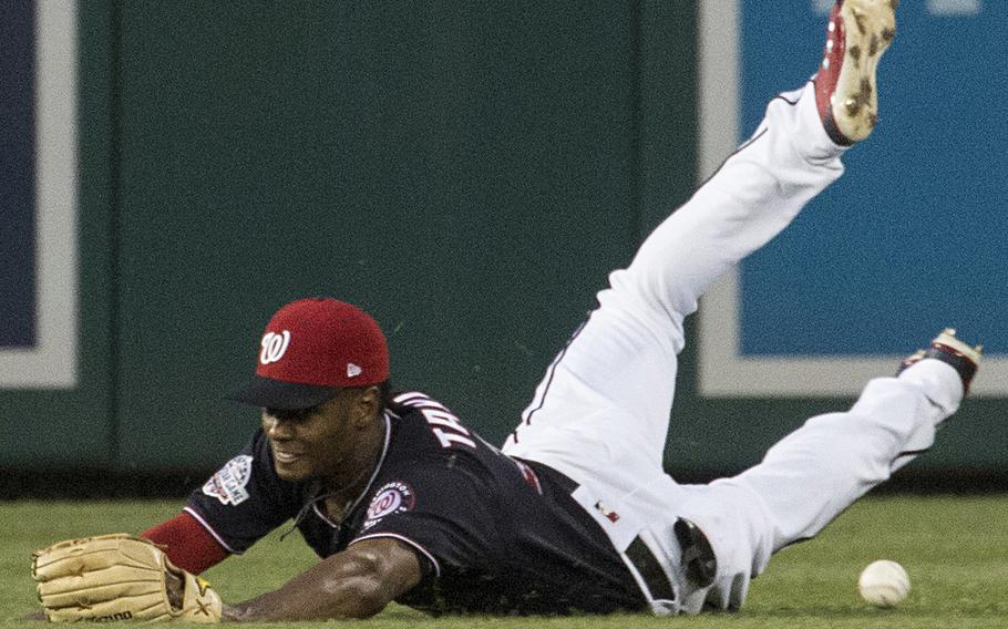 Washington Nationals center fielder Michael A. Taylor misses his attempt at a diving catch on a line drive by Franmil Reyes of the San Diego Padres in the fourth inning of a game at Washington, D.C., May 22, 2018.