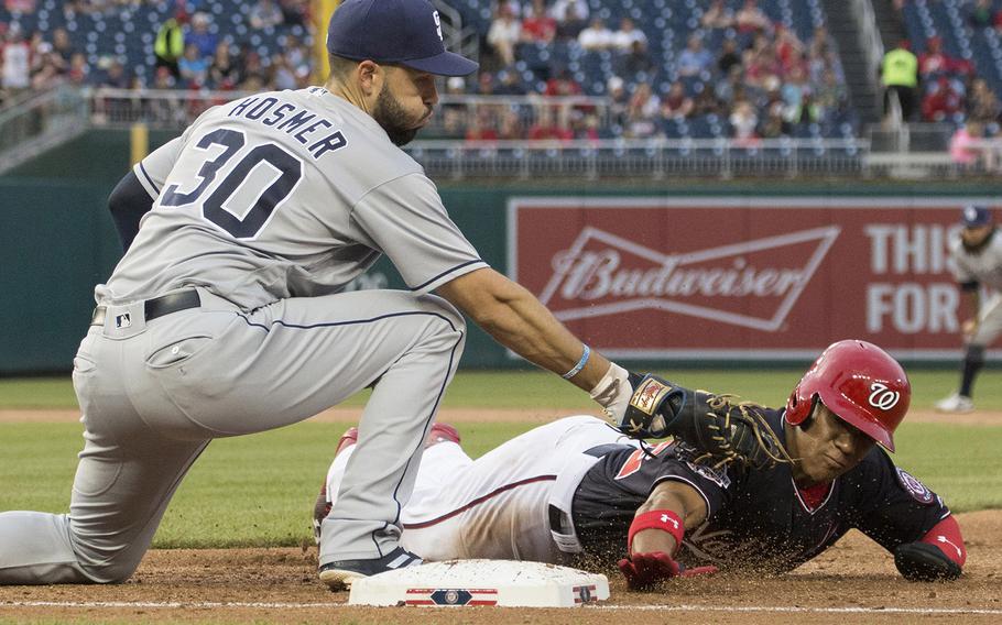 Washington Nationals baserunner Juan Soto is picked off first base in the second inning of a game against the San Diego Padres at Washington, D.C., May 22, 2018. Applying the tag is the Padres' Eric Hosmer.