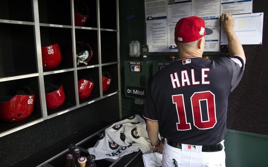 Washington Nationals bench coach Chip Hale works on the lineup card before a game against the San Diego Padres at Nationals Park on May 22, 2018.