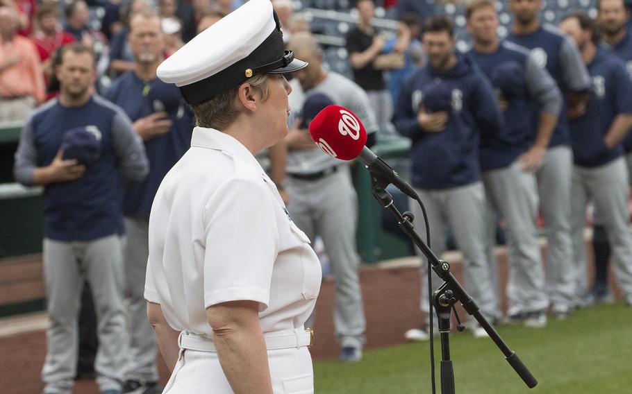 Chief Musician Shana Sullivan of the U.S. Navy Band sings the national anthem as San Diego Padres players and coaches stand on the baseline before a game at Nationals Park in Washington, D.C., May 22, 2018.