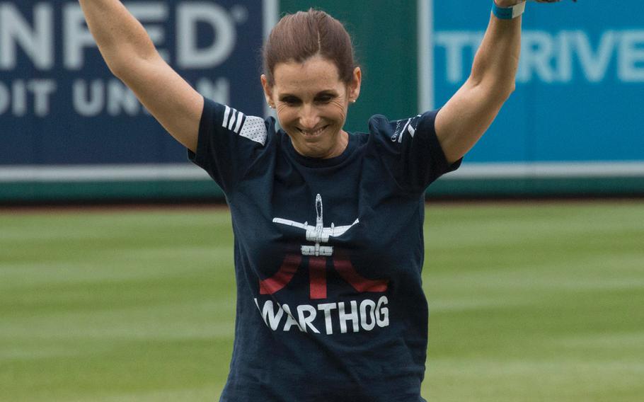 Rep. Martha McSally, R-Ariz., celebrates after throwing the ceremonial first pitch before a game between the Washington Nationals and San Diego Padres in Washington, D.C., May 22, 2018. McSally is wearing a t-shirt depicting the A-10 "Warthog" aircraft, which she flew as the first female combat pilot in the U.S. military.
