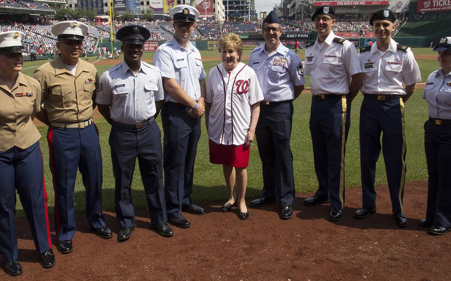 Former Sen. Elizabeth Dole, the founder of an organization that supports military caregivers, poses with servicemembers before a game between the Washington Nationals and Boston Red Sox in Washington, D.C., July 4, 2018.