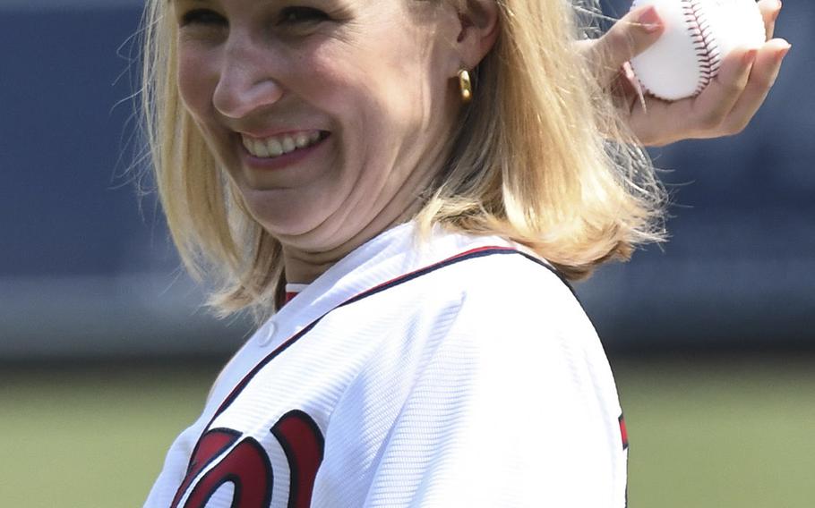 Military caregiver Megan Smith throws out the ceremonial first pitch before a game between the Washington Nationals and Boston Red Sox in Washington, D.C., July 4, 2018.